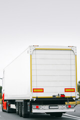 White truck rear side view on road