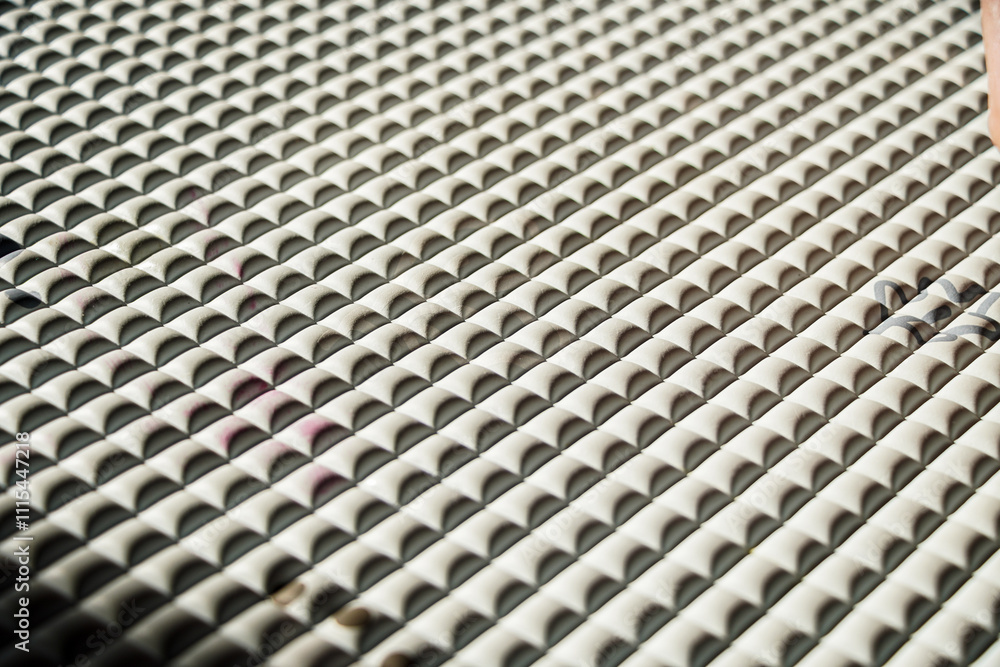Poster close-up view of a grey textured surface with repeating pattern. abstract grey textured surface.