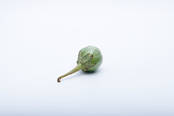 Healthy green round mini eggplant vegetable photographed with white base and background