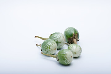 Healthy green round mini eggplant vegetable photographed with white base and background