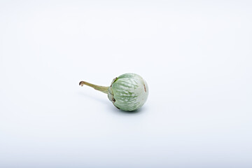 Healthy green round mini eggplant vegetable photographed with white base and background