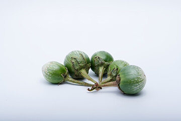 Healthy green round mini eggplant vegetable photographed with white base and background
