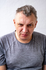 Obraz premium portrait of an aggressive angry man with a face distorted with hatred and malice