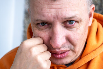 distorted face of a sad and sorrowful very upset man