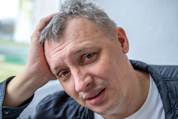 distorted face of a sad and sorrowful very upset man