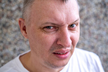 distorted face of a sad and sorrowful very upset man