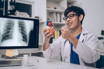 At the clinic, the cardiologist examined a human patient's medicals, discussing disease management and health care options in detail to ensure optimal health and effective medicine.