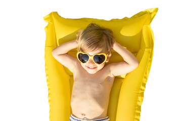 Happy child playing outdoor on summer vacation.  Kid lying on yellow inflatable mattress. Transparent  background