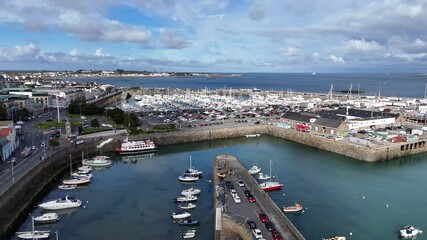 St Peter Port harbour Guernsey. Flight over the careening hard towards Cambridge Berth and QEII Marina on bright sunny day with views over Belle Greve Bay and St Sampson in the distance