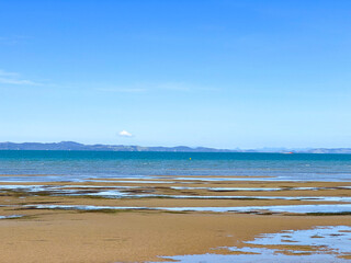 Blue ocean in Auckland, New Zealand with the NZ flag.