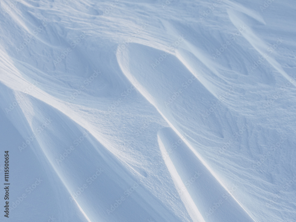 Wall mural snow texture. wind sculpted patterns on snow surface. wind in the tundra and in the mountains on the