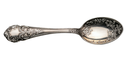 Delicate silver spoon adorned with intricate floral patterns lies on a smooth surface, showcasing a blend of beauty and functionality from a bygone era, inviting admiration and nostalgia
