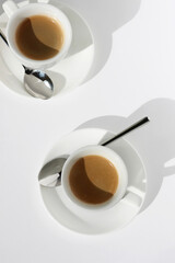 Two Cups of Freshly Brewed Espresso Coffee Overhead View on White Background. Cafe.	