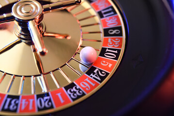Ball fixed on the red five of a casino roulette