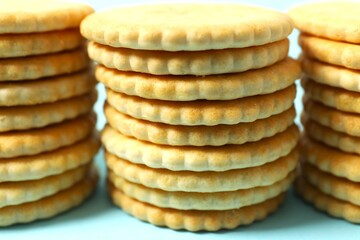Delicious crispy crackers cookies on color background