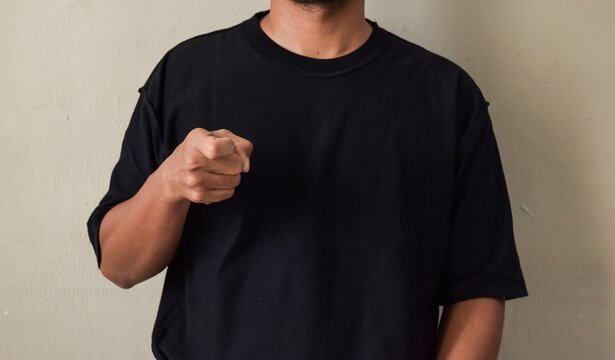 Young man interpreter of brazillian sign language, Libras, making the letter X