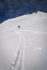 Ski touring in the french alps. Skier in the fresh snow.