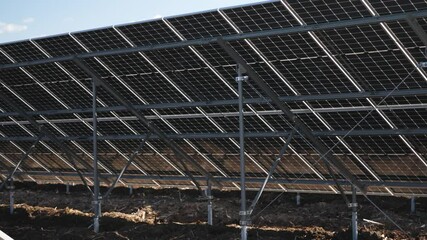 Low-angle shot under solar panels, emphasizing structural design and eco-friendly energy systems underside technolgoy and scaffolding