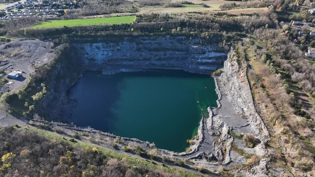 Aerial top down shot of natural lake of Frazier Quarry in Harrisonburg, Virginia. Suburb district in USA. New developed housing area project.