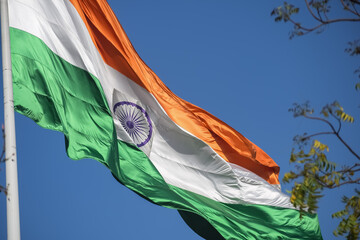 India flag flying high at Connaught Place with pride in blue sky, India flag fluttering, Indian Flag on Independence Day and Republic Day of India, tilt up shot, Waving Indian flag, Har Ghar Tiranga