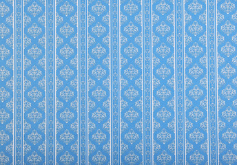 Old wallpaper on the wall. Old wallpaper for texture or background.