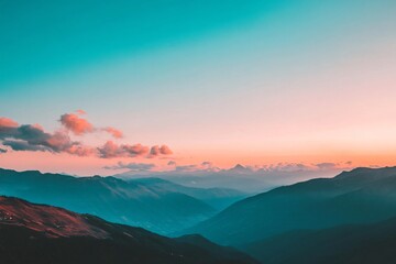 Obraz premium Clear sky over a sprawling mountain range, sunset glow with three-quarters sky in frame, orange and pink colors fading to blue at dusk 1