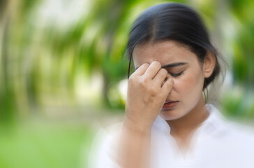 South Asian woman suffering from migraine, vertigo, dizziness, headache, stress, stressful lifestyle, fatigue, overwork, mental fatigue, life problem