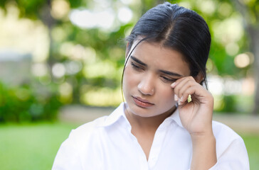 Sad and unhappy Indian, South Asian woman crying outdoors