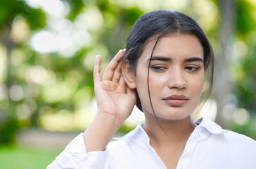 South Asian Indian Woman's Hearing Ear Captures the Essence of News, Fake or Real News, Hard of hearing or ear health Concept