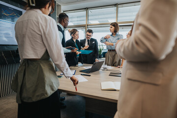 A multicultural group of business people engaged in a dynamic meeting, discussing strategies and...