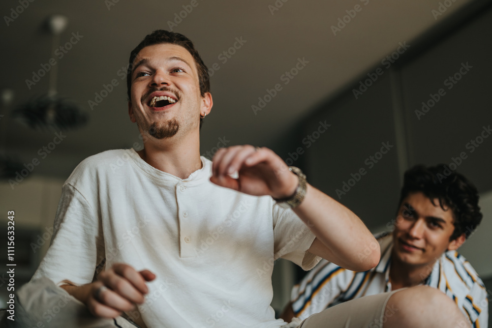 Sticker Two young men enjoy a moment of laughter while relaxing at home. Their cheerful expressions highlight friendship and happiness in a casual environment.