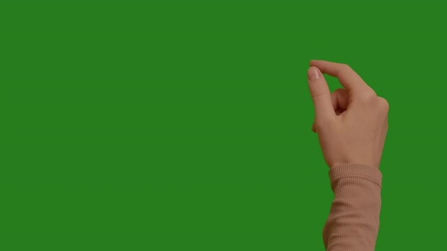 Woman swiping on chroma key green screen background. Touching Chroma Key pack. Female hand showing multitouch gestures for touch screen: Vertical, Horizontal slide, Scrolling. Interface concept.