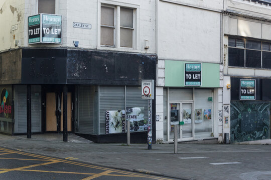 group of shops with to let notices symbolising the crisis in many town and city High Streets whose trade has been affected by the growth of online shopping