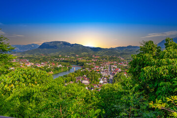 Luang Prabang Laos surrounded by the high mountains and the Mekong River. This lovely city is nestled in the high mountains and tropical rainforest