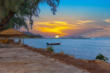 Colourful Skies Sunset over Rawai Beach and Chalong Bay Patong Pa Tong Beach in Phuket island Thailand. Lovely turquoise blue waters, lush green mountains colourful skies