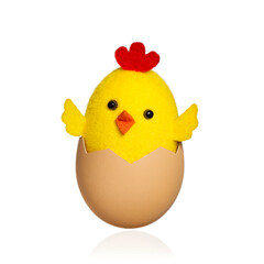 Funny chick in a shell isolated on white background. Toy cockerel hatching from an egg.