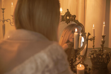 Bride European woman near magic of candles, magical attributes, rituals and esoteric concept