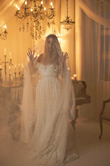 Bride European woman near magic of candles, magical attributes, rituals and esoteric concept