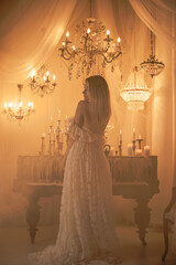 Bride European woman near magic of candles, magical attributes, rituals and esoteric concept