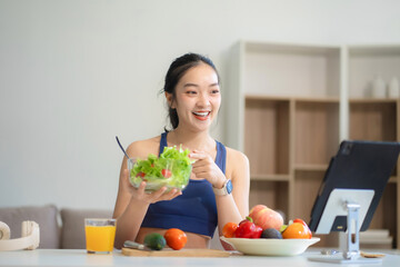 Fit woman enjoys healthy fruit breakfast after yoga training. fitness, nutrition, home lifestyle.