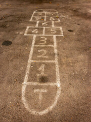 A hopscotch game painted in the tarmac of a pavement