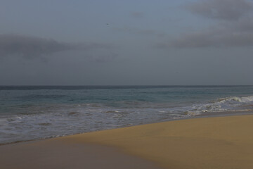 Beautiful turquoise waves of Atlantic Ocean on grey gloomy day in Cabo Verde.