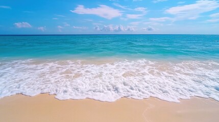 Fototapeta premium A serene beach scene featuring gentle waves, soft sand, and a clear blue sky, perfect for relaxation and tranquility.