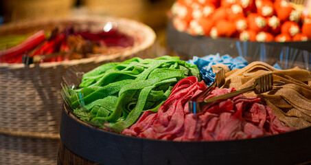 Fototapeta premium Variety of colorful candies displayed at sweet store. Large choice of sweets in a candy shop.