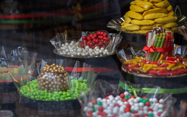 Various choices candy on display shelf in sweet-shop.