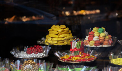 Various choices candy on display shelf in sweet-shop.