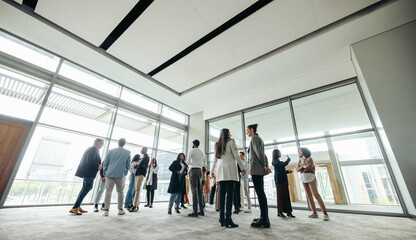 Businesspeople networking at corporate event in large modern office
