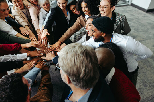 Diverse team showing teamwork and collaboration with hands in during corporate meeting