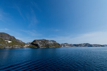 Prins Christian Sund Greenland mountain fjord with floating ice and shore iceberg on a summer day