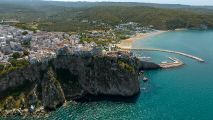 Aerial view of houses and buildings built on a cliff overlooking the Mediterranean Sea. The town is...